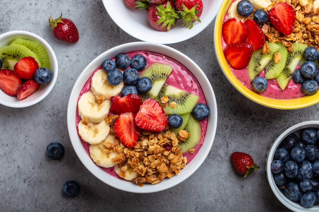 Bowls of fresh fruit, berries and granola