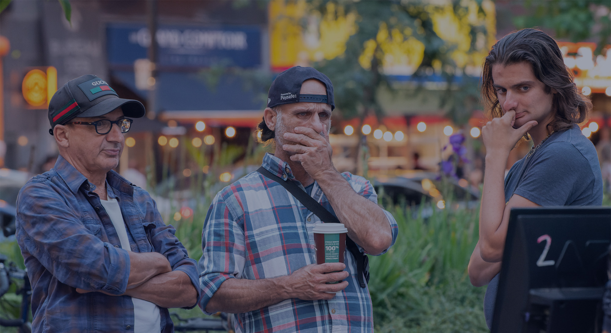 Three WTF activists chatting together at an outreach event in the evening