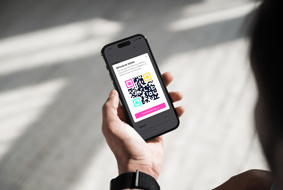 A hand holding a phone displaying a MyStats QR code