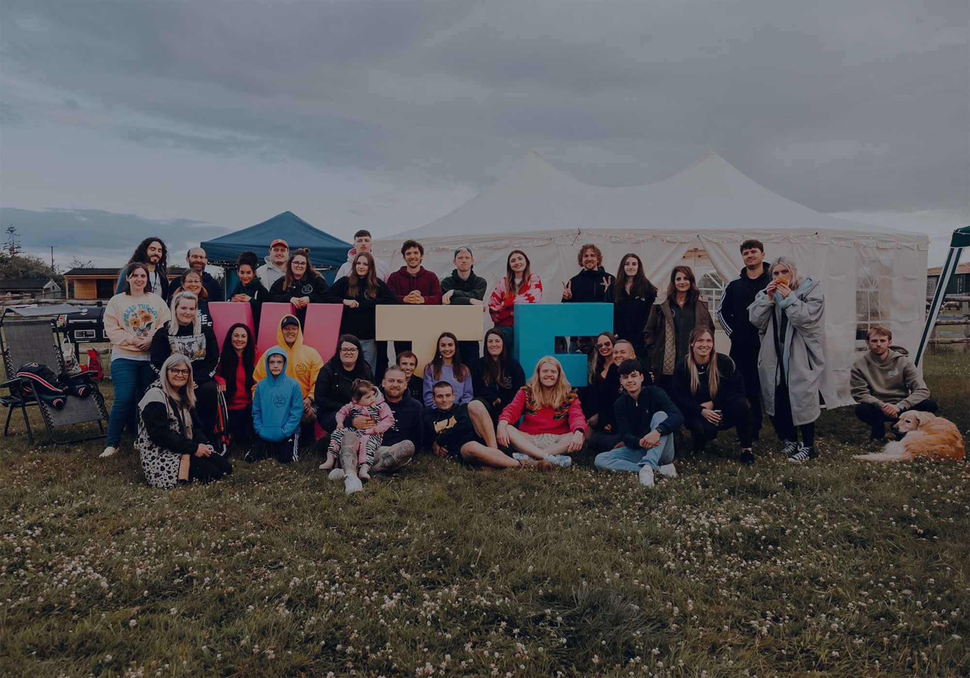 A large group of We The Free volunteers posing together outdoors