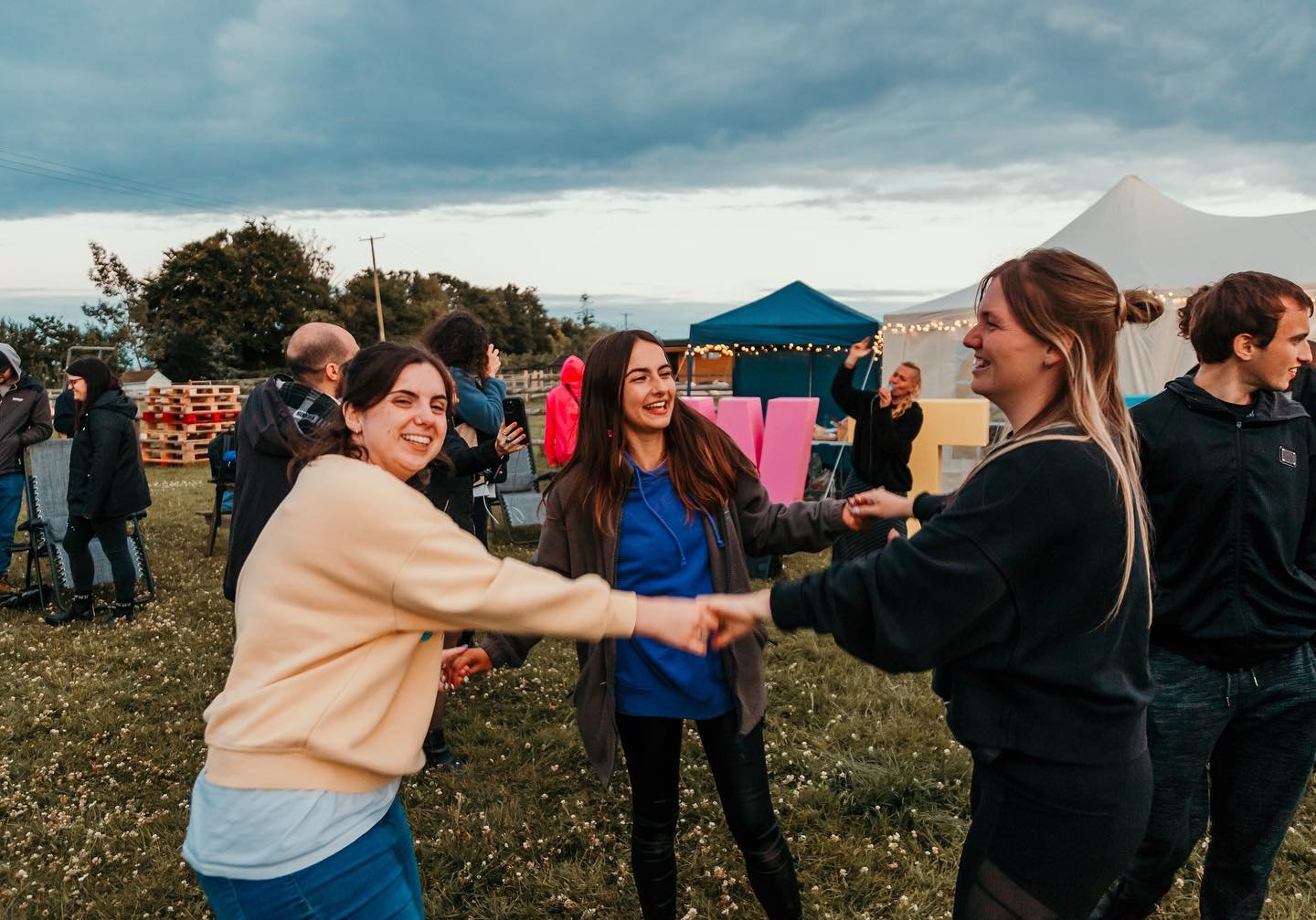 WTF volunteers embracing in a circle during a team celebration
