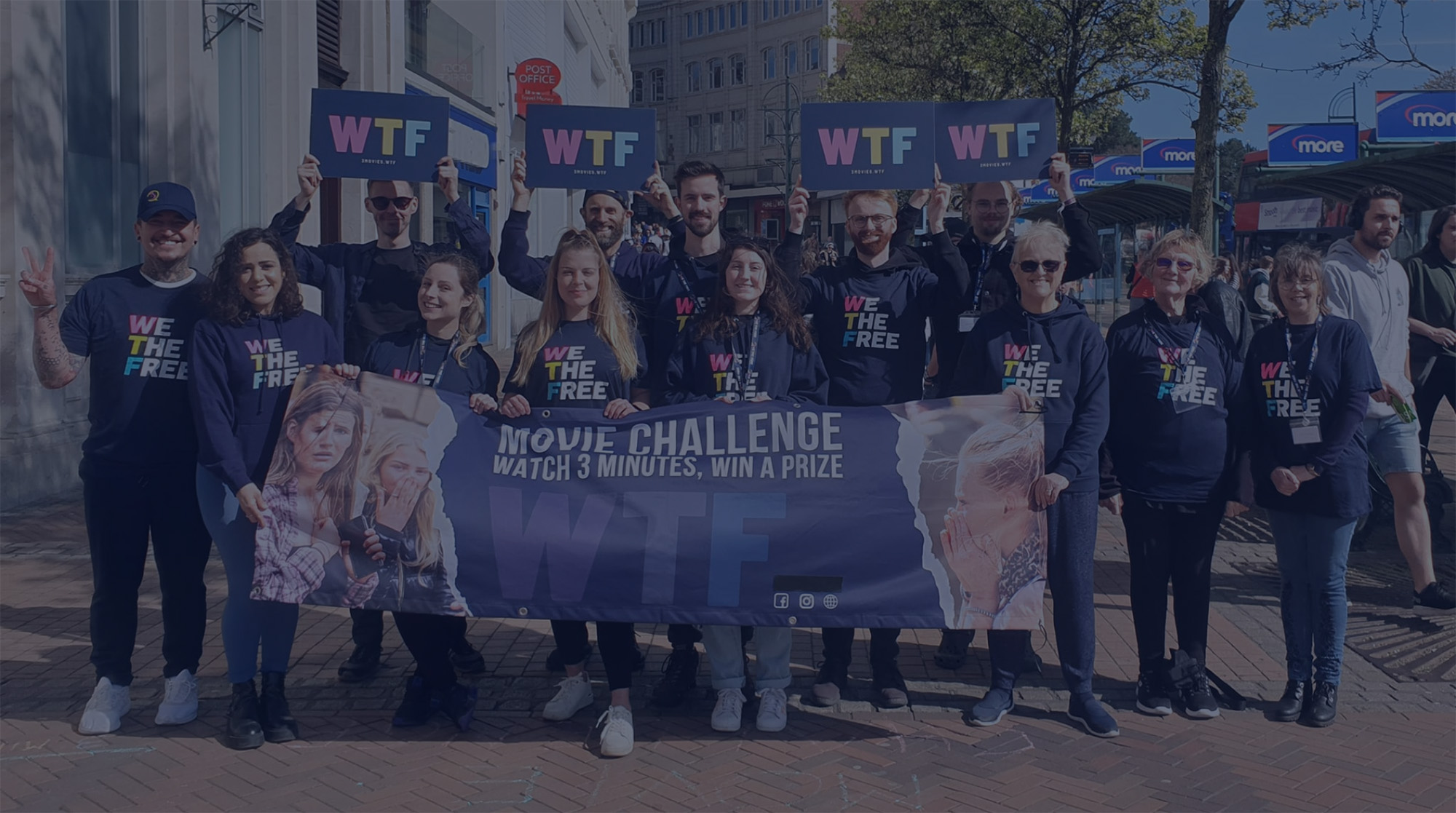 WTF volunteers holding placards at a street outreach event