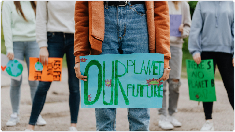 People holding signs reading "There is no planet B"